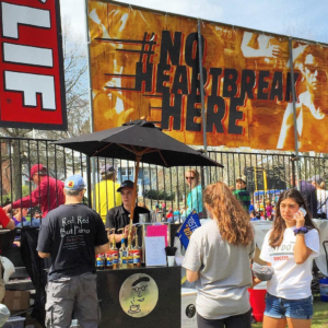 Barista with coffee cart working at Heartbreak Hill during the Boston Marathon