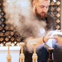 Barista steaming milk at mobile espresso cart Boston for coffee catering event tucker finerty photograph
