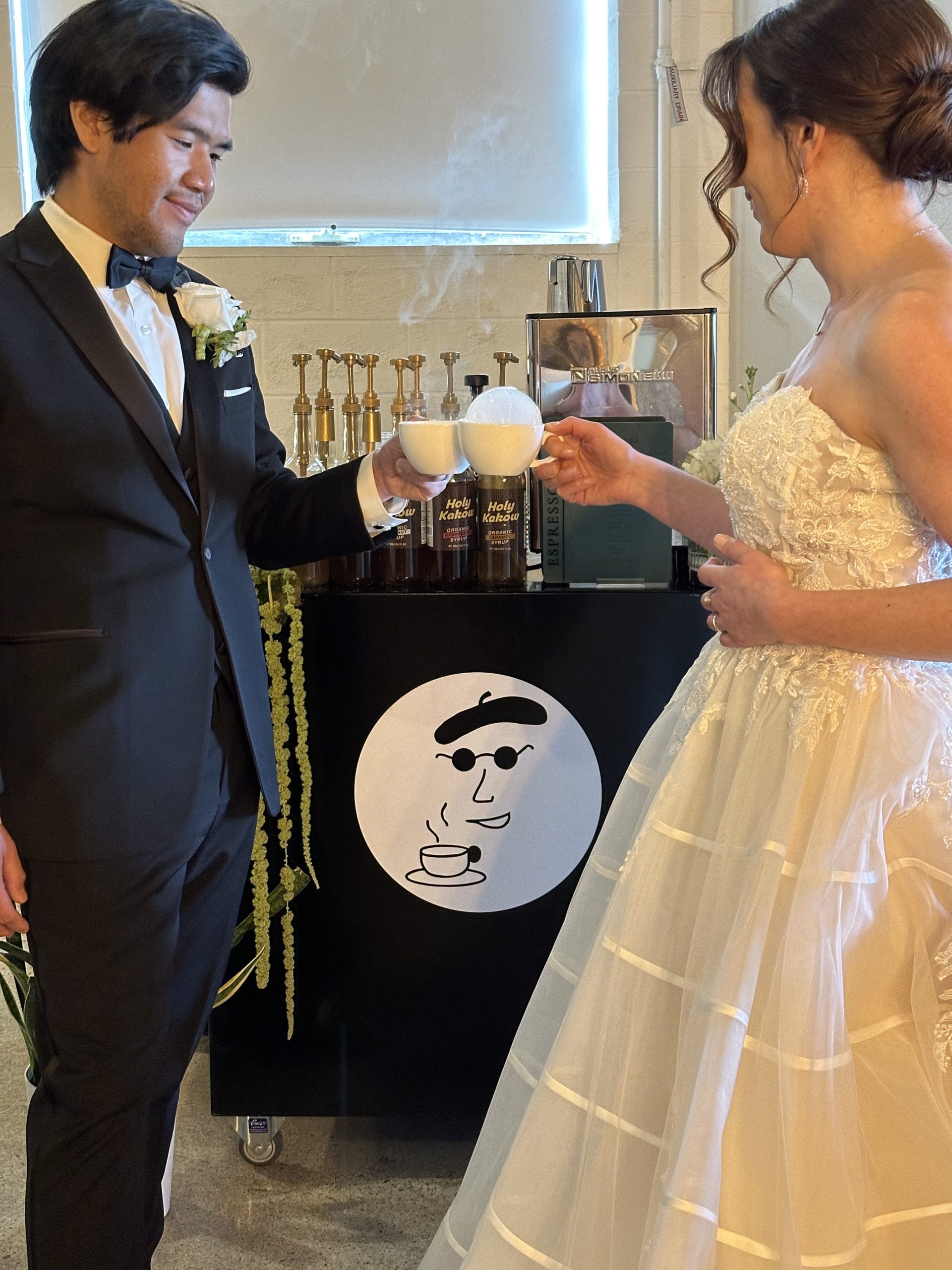 Bride and groom toasting with two Bubble Cloud coffee cart addon in front by Espresso Dave's Coffee Catering. Lexi Foster Photography