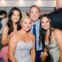 Bride posing with guests with specialty iced espresso based drinks from Espresso Dave’s Coffee Catering