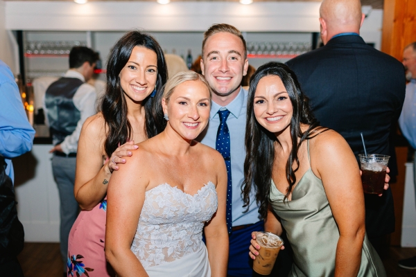 Bride posing with guests with specialty iced espresso based drinks from Espresso Dave’s Coffee Catering