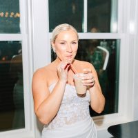 Bride enjoying an iced latte from Espresso Dave’s Coffee Catering's wedding coffee bar during her evening reception