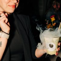 Guest holding an iced latte with Espresso Dave’s Bubble Cloud effect at a wedding reception