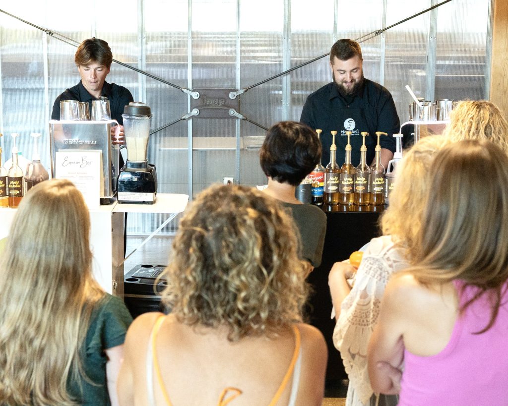 Espresso Dave’s Coffee Catering serving made to order drinks at a corporate event espresso bar in Boston with guests gathered and interacting with baristas